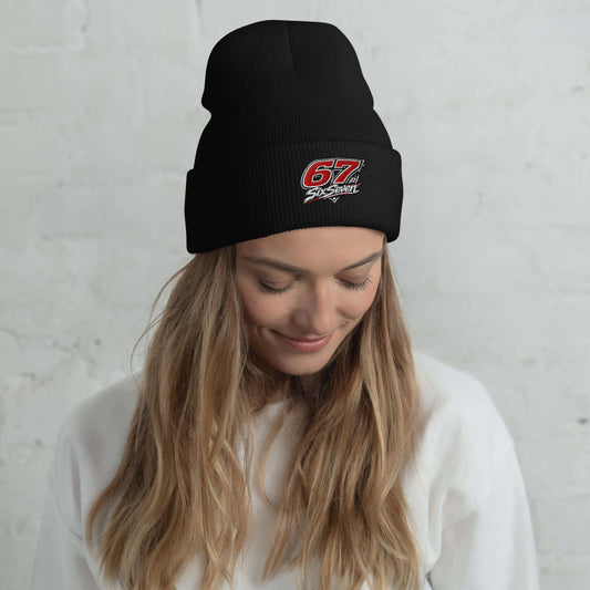 Cuffed Beanie worn by a model with long hair, showcasing a sleek black design and stylish embroidered logo.