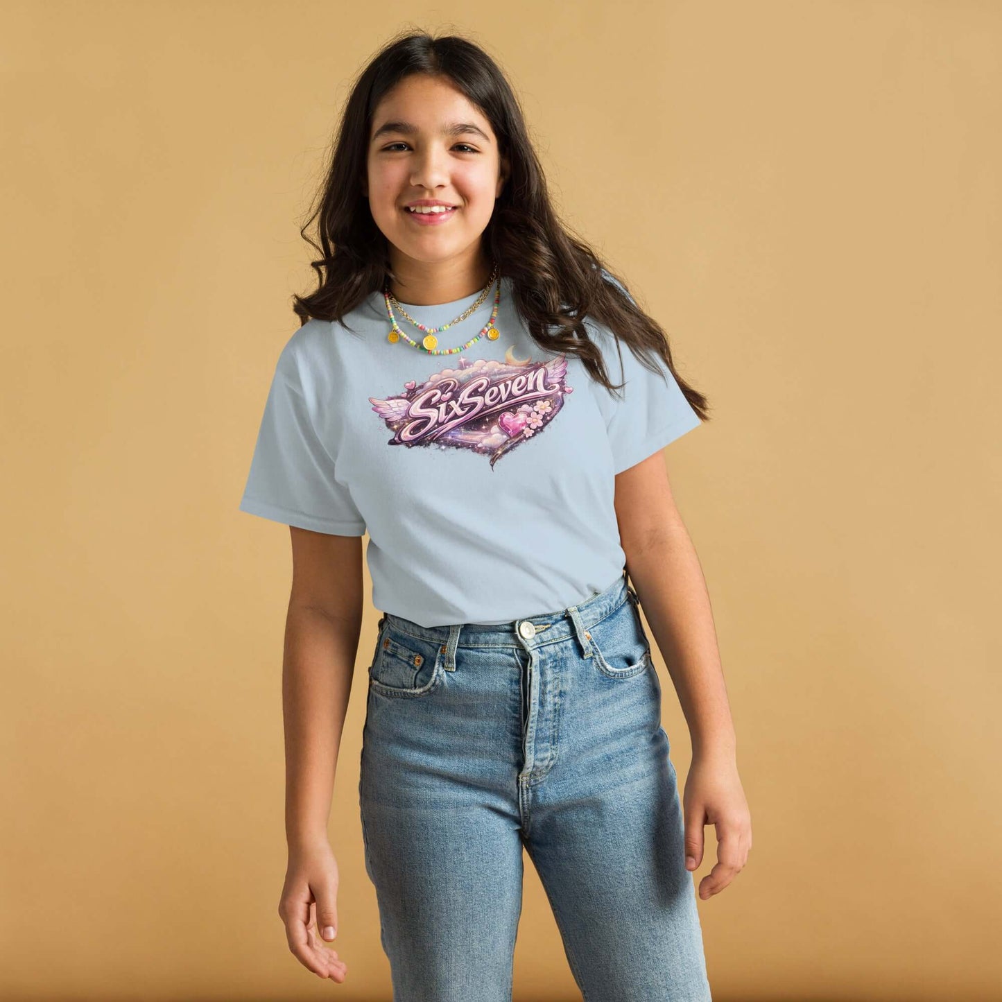 Youth classic tee featuring a fun graphic design on a girl smiling against a plain beige background.