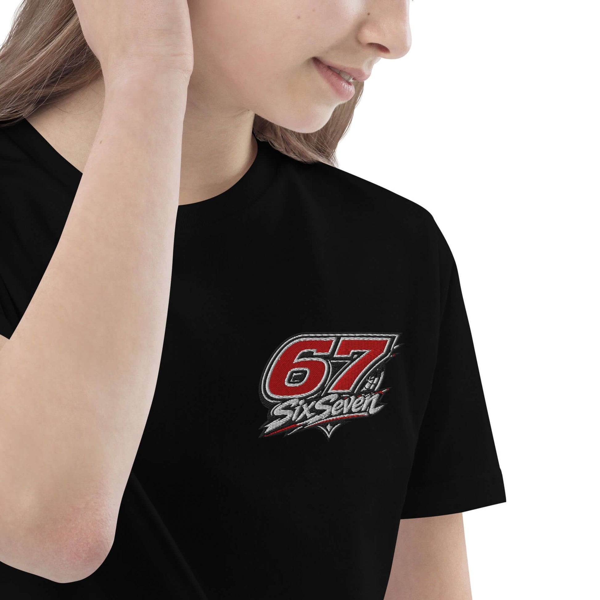 Girl wearing a black Organic cotton kids t-shirt with a '67 SixSeven' logo design.